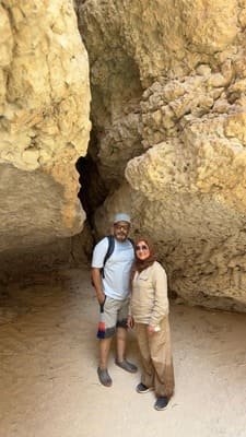 Tourists in a narrow limestone passage on the Wadi Shab hike