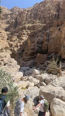 Hiking the rocky canyon path at Wadi Shab Oman from Muscat
