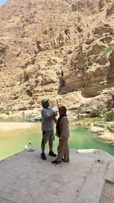 Emerald turquoise pools at Wadi Shab with limestone cliffs